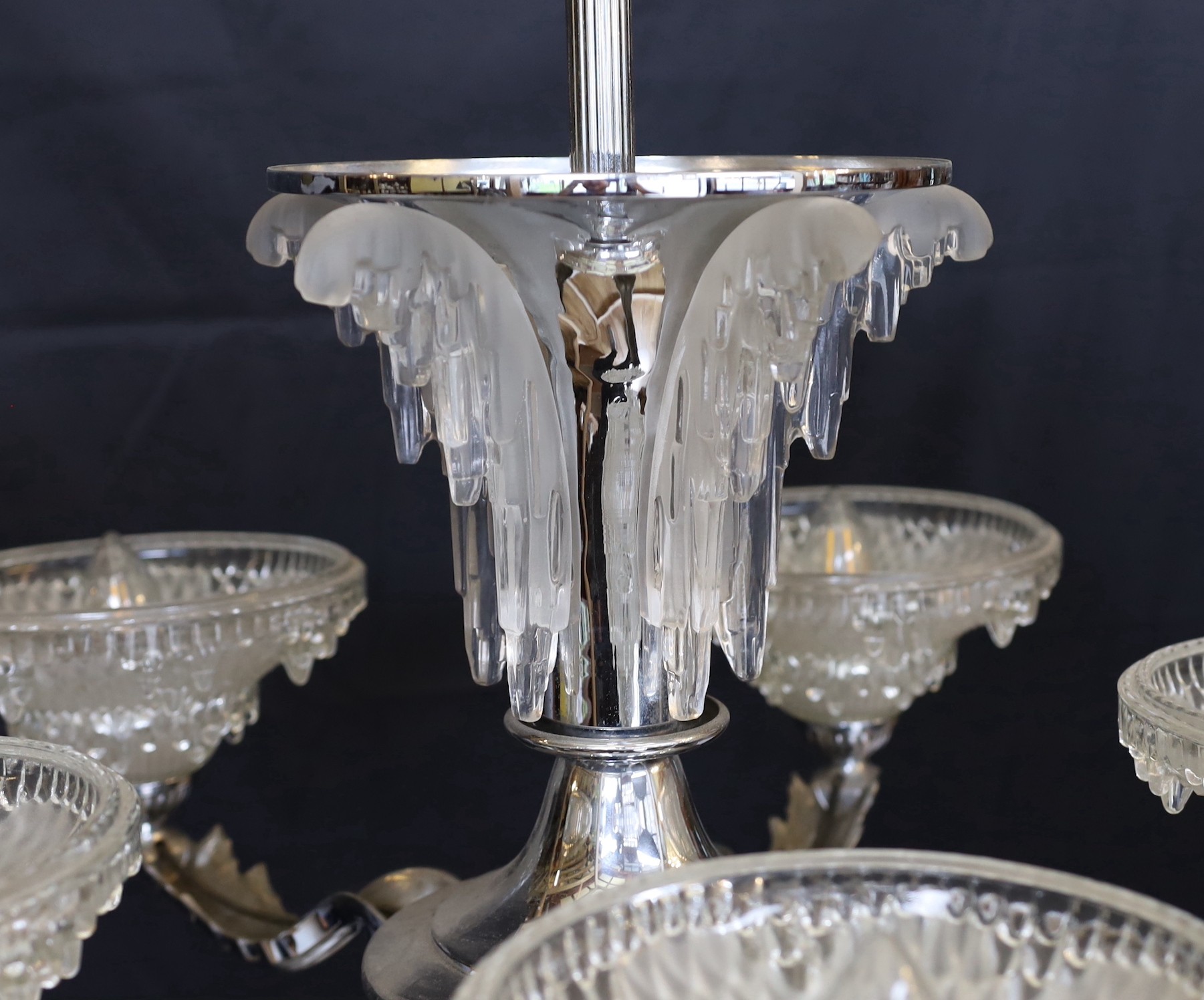 A French Art Deco chrome plated and glass five light chandelier, with scrolling branches and 'melting ice' mounts and shades, drop 85cm. width 70cm
